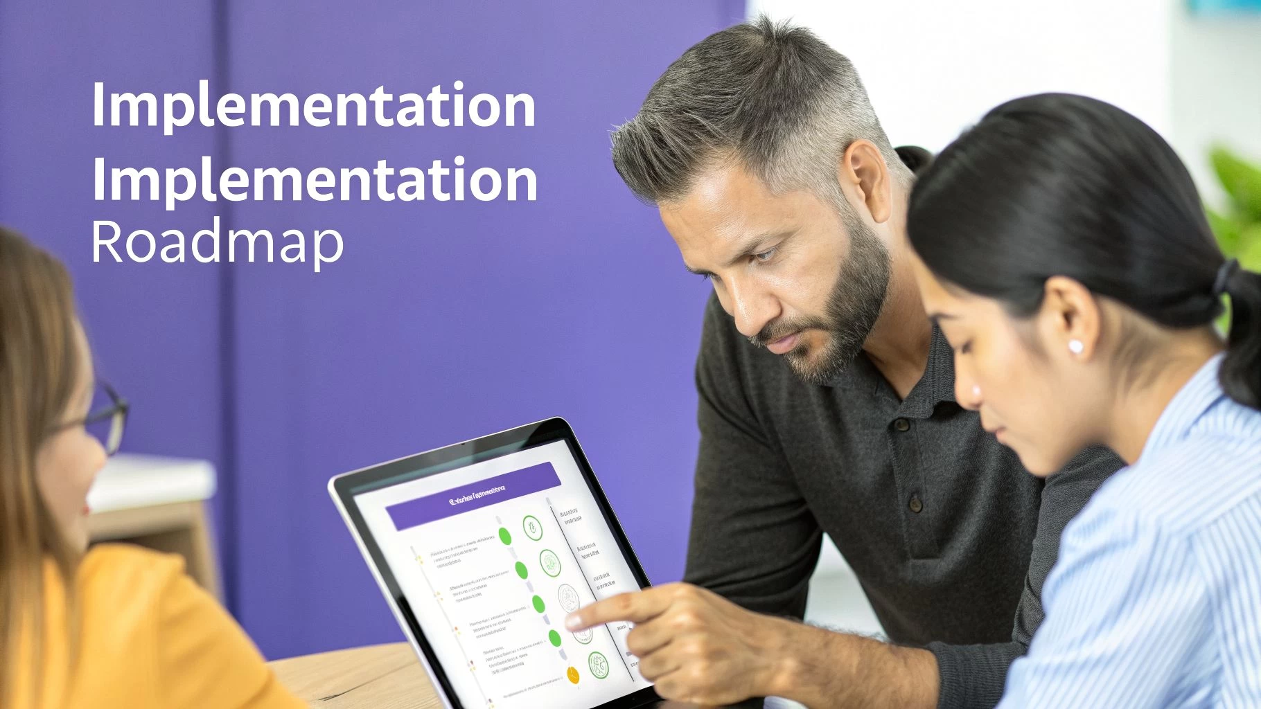 Three business people collaborating and reviewing an implementation roadmap on a digital tablet.